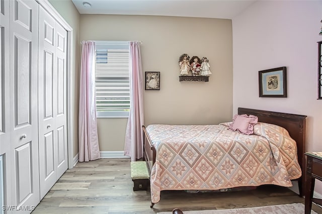 bedroom with a closet and light wood-type flooring