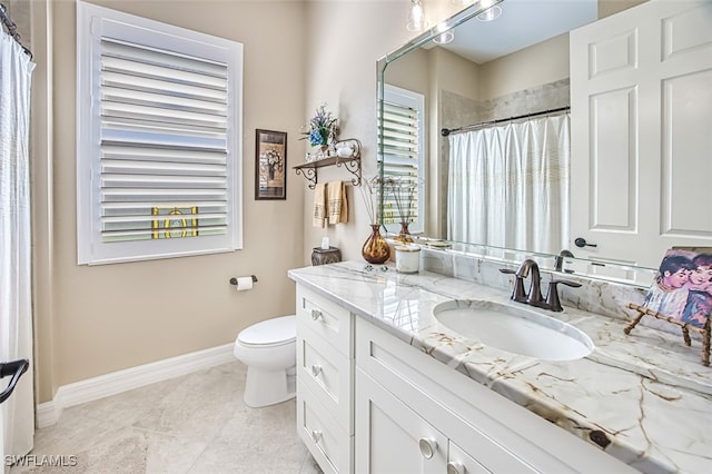 bathroom with vanity, a shower with curtain, toilet, and a healthy amount of sunlight