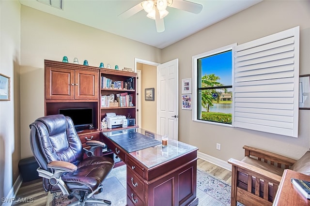 office featuring light hardwood / wood-style floors and ceiling fan