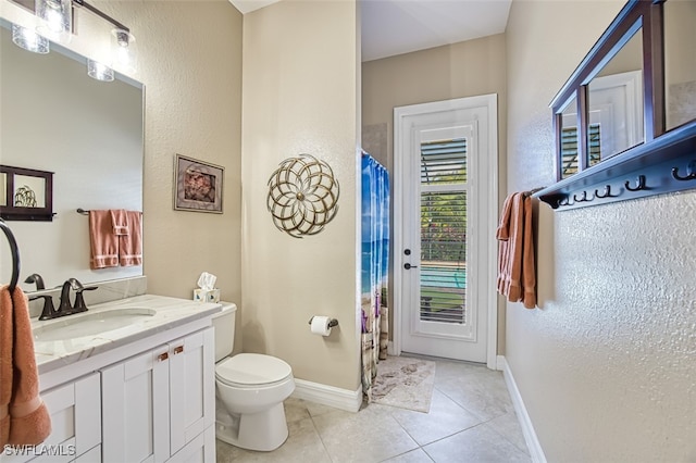 bathroom featuring vanity, toilet, and tile patterned flooring