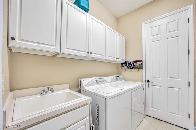 laundry room with cabinets, sink, and washer and dryer