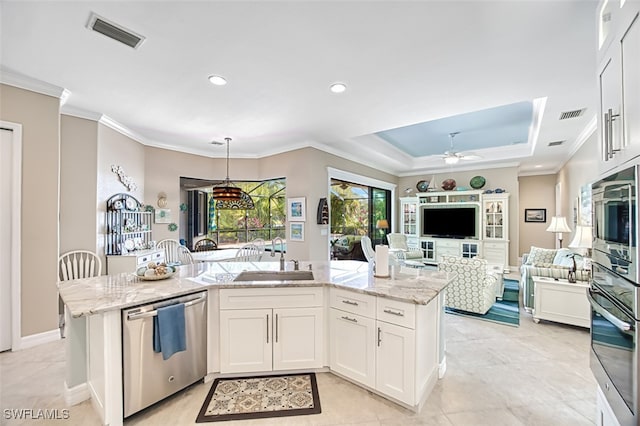 kitchen with white cabinetry, sink, light stone counters, and stainless steel appliances