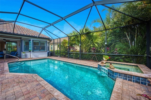 view of swimming pool featuring an in ground hot tub, a lanai, and a patio area