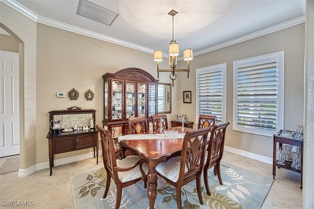 dining room featuring crown molding, light tile patterned flooring, and an inviting chandelier