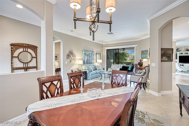 dining space featuring an inviting chandelier, ornamental molding, and light tile patterned flooring