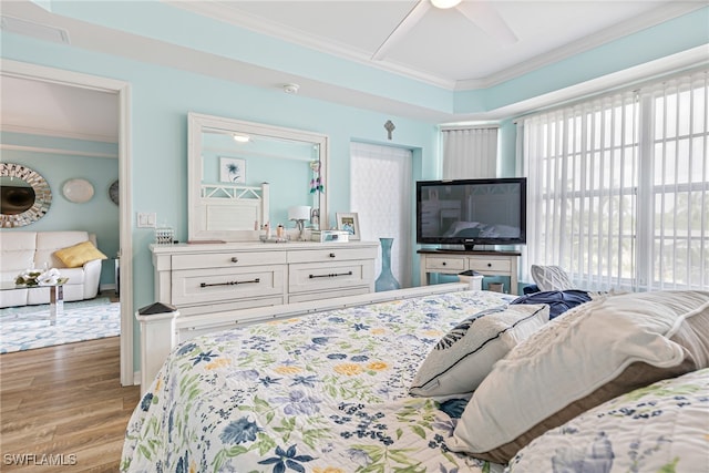 bedroom with crown molding and light hardwood / wood-style floors