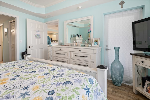 bedroom featuring ornamental molding and light hardwood / wood-style flooring