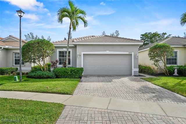 view of front of home featuring a garage and a front lawn