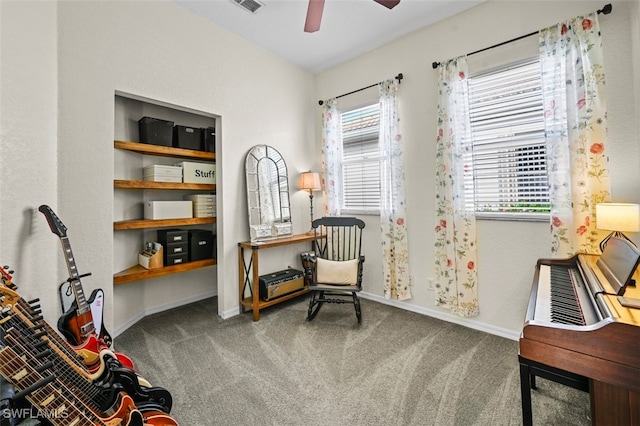 living area with carpet and ceiling fan