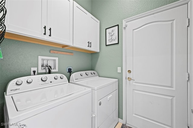 laundry room featuring cabinets and washing machine and dryer