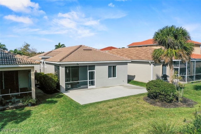 back of property featuring a yard and a patio area