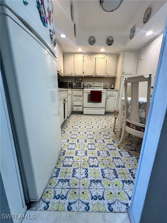 kitchen featuring white cabinetry and white appliances