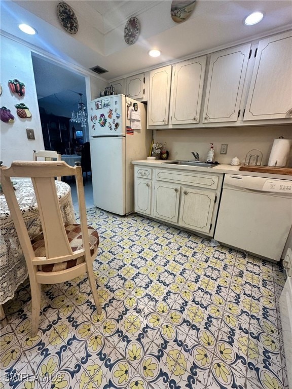 kitchen featuring white cabinetry, white appliances, and sink