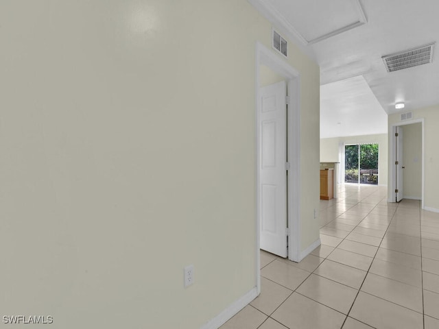 hall featuring light tile patterned floors