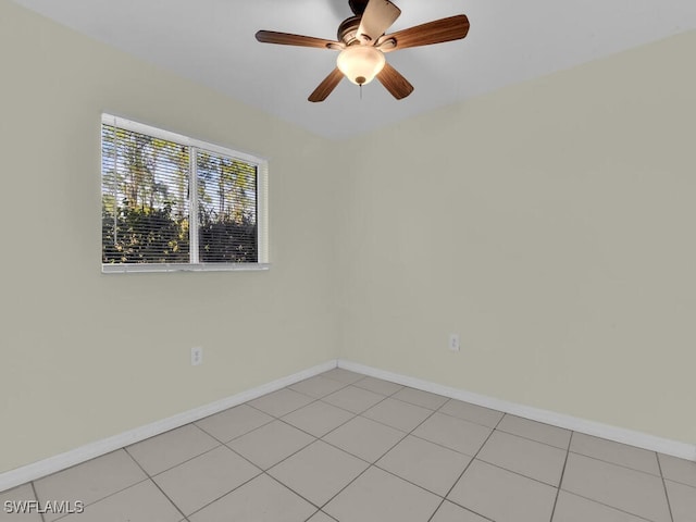 tiled empty room featuring ceiling fan