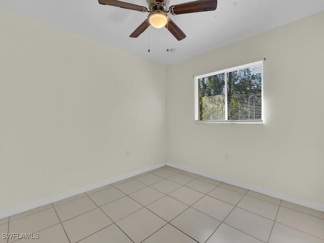 spare room featuring light tile patterned floors and ceiling fan