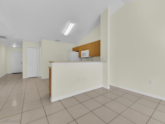 interior space featuring lofted ceiling and light tile patterned floors