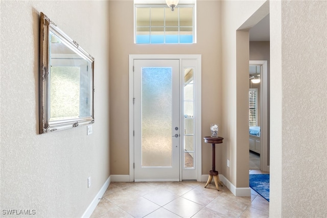 tiled foyer entrance featuring a wealth of natural light