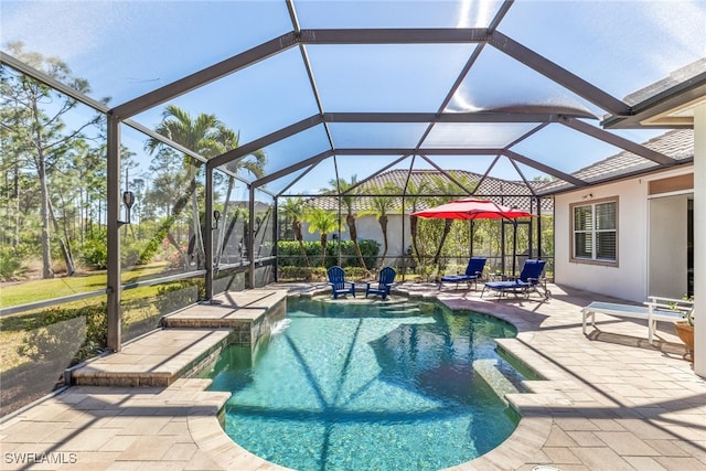 view of pool with pool water feature, a patio, a hot tub, and glass enclosure