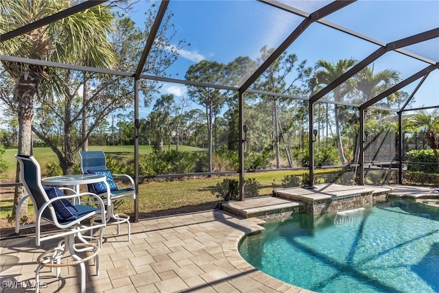 view of swimming pool featuring pool water feature, a lanai, and a patio area