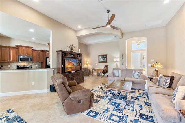 living room with ceiling fan and light tile patterned floors