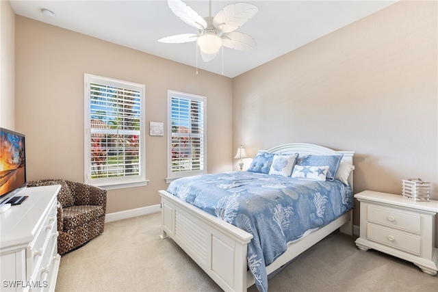 bedroom featuring light carpet and ceiling fan