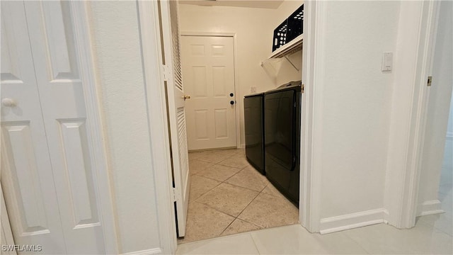 laundry area featuring separate washer and dryer and light tile patterned floors