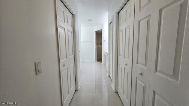 corridor with light tile patterned floors