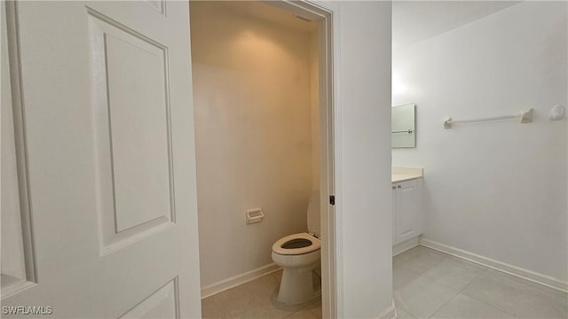 bathroom with vanity, tile patterned floors, and toilet