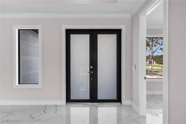 foyer with ornamental molding and french doors