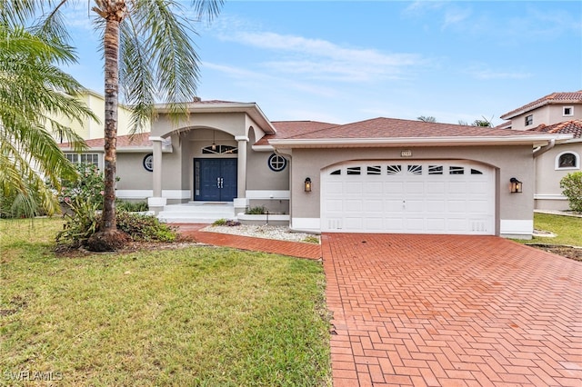 view of front facade with a garage, a front lawn, decorative driveway, and stucco siding