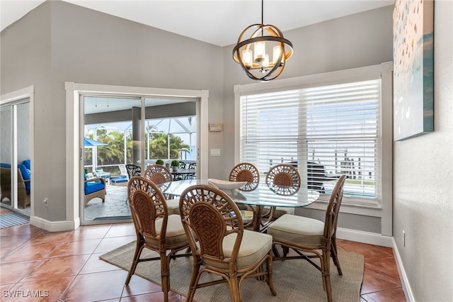 dining room with an inviting chandelier, tile patterned floors, and plenty of natural light