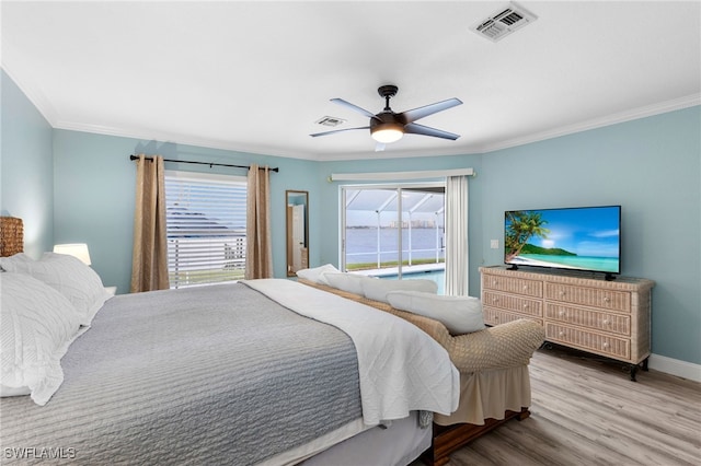 bedroom featuring hardwood / wood-style floors, crown molding, and ceiling fan