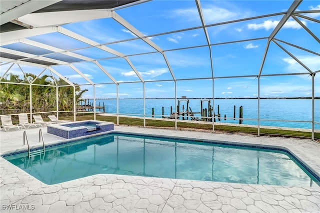 view of pool with a patio, a lanai, a water view, and an in ground hot tub