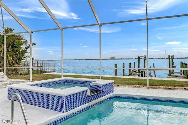 view of swimming pool featuring a water view, a lanai, a patio area, and a hot tub