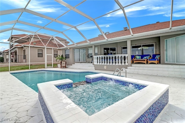 view of pool featuring an in ground hot tub, a lanai, and a patio area