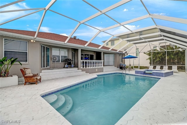 view of pool featuring a lanai, a jacuzzi, and a patio