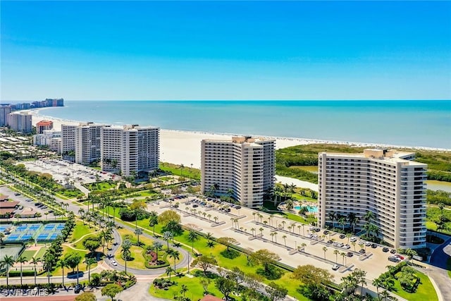 bird's eye view featuring a water view and a beach view