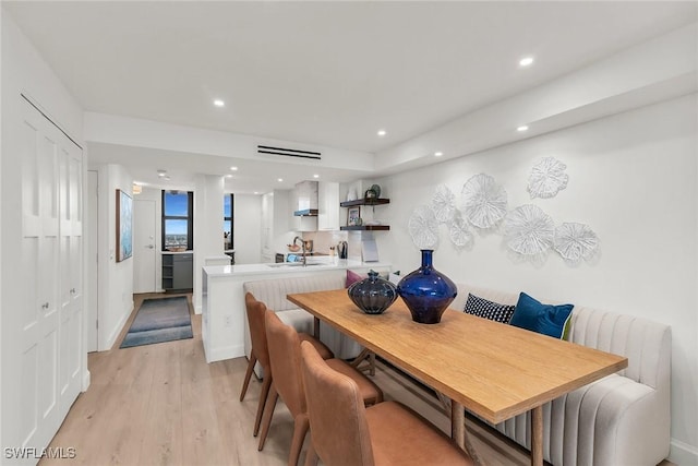 dining room with light hardwood / wood-style floors and sink