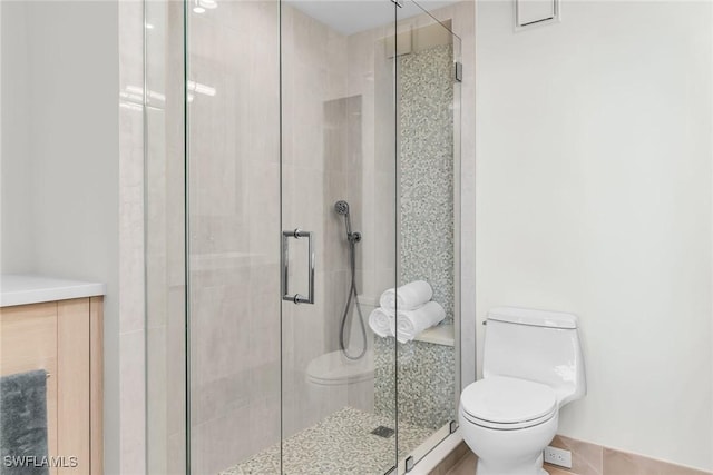 bathroom with walk in shower and toilet