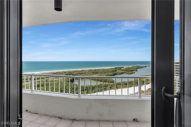 balcony with a water view and a beach view