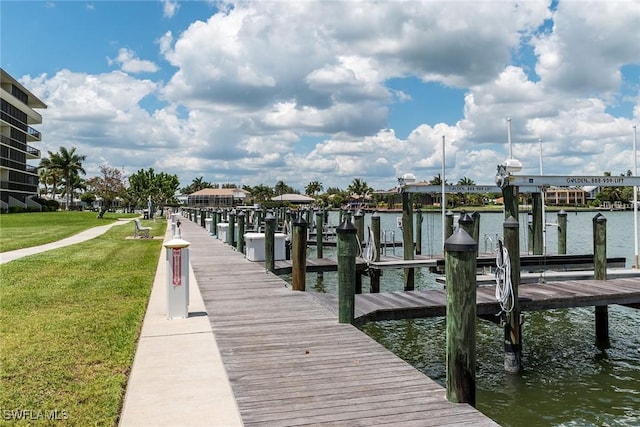 dock area featuring a water view and a lawn