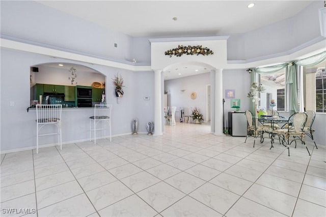 interior space with light tile patterned floors and ornate columns