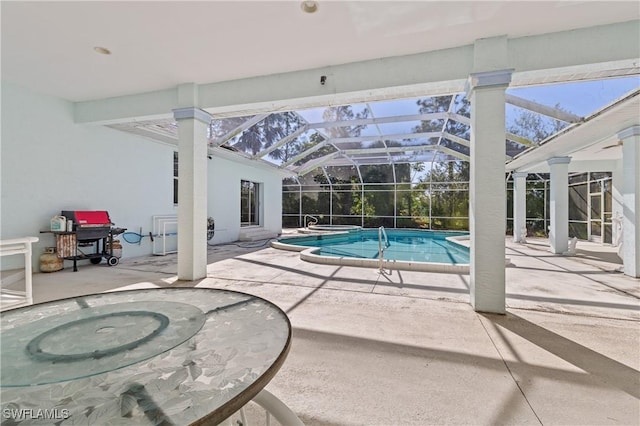 view of pool with a hot tub, a patio, and glass enclosure