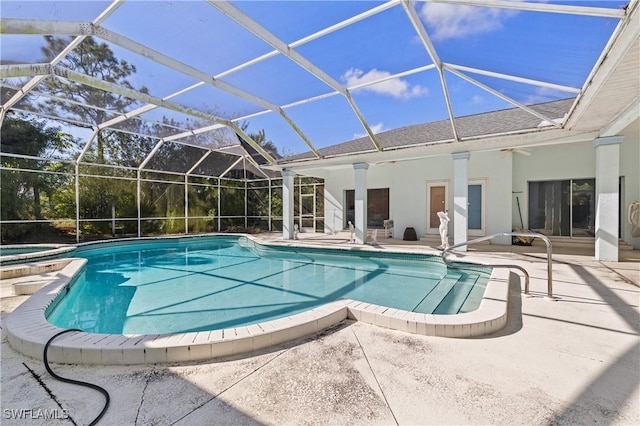 view of swimming pool featuring a lanai, a patio area, and an in ground hot tub