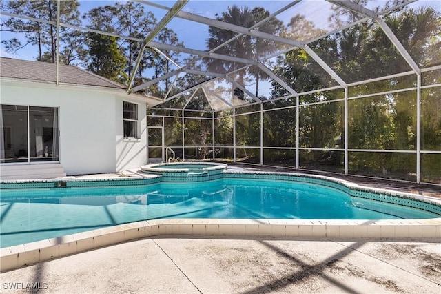 view of pool featuring an in ground hot tub, a lanai, and a patio area