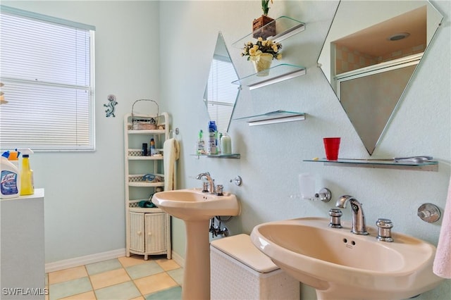 bathroom featuring sink and a shower with shower door