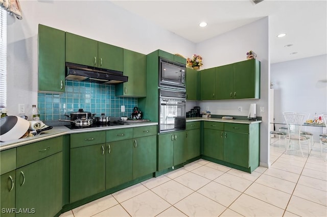 kitchen with green cabinetry, light tile patterned floors, decorative backsplash, and black appliances