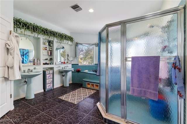 bathroom with sink and a shower with shower door