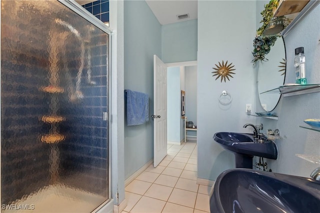 bathroom featuring sink, a shower with shower door, and tile patterned flooring